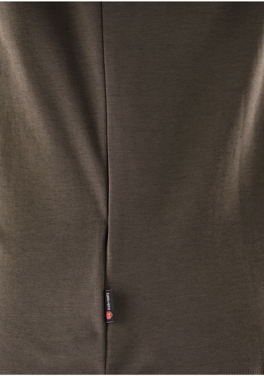 Close-up of a brown fabric with a brand label on a dark background