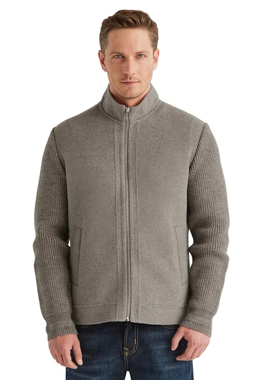 Man wearing a gray zip-up sweater on a white background